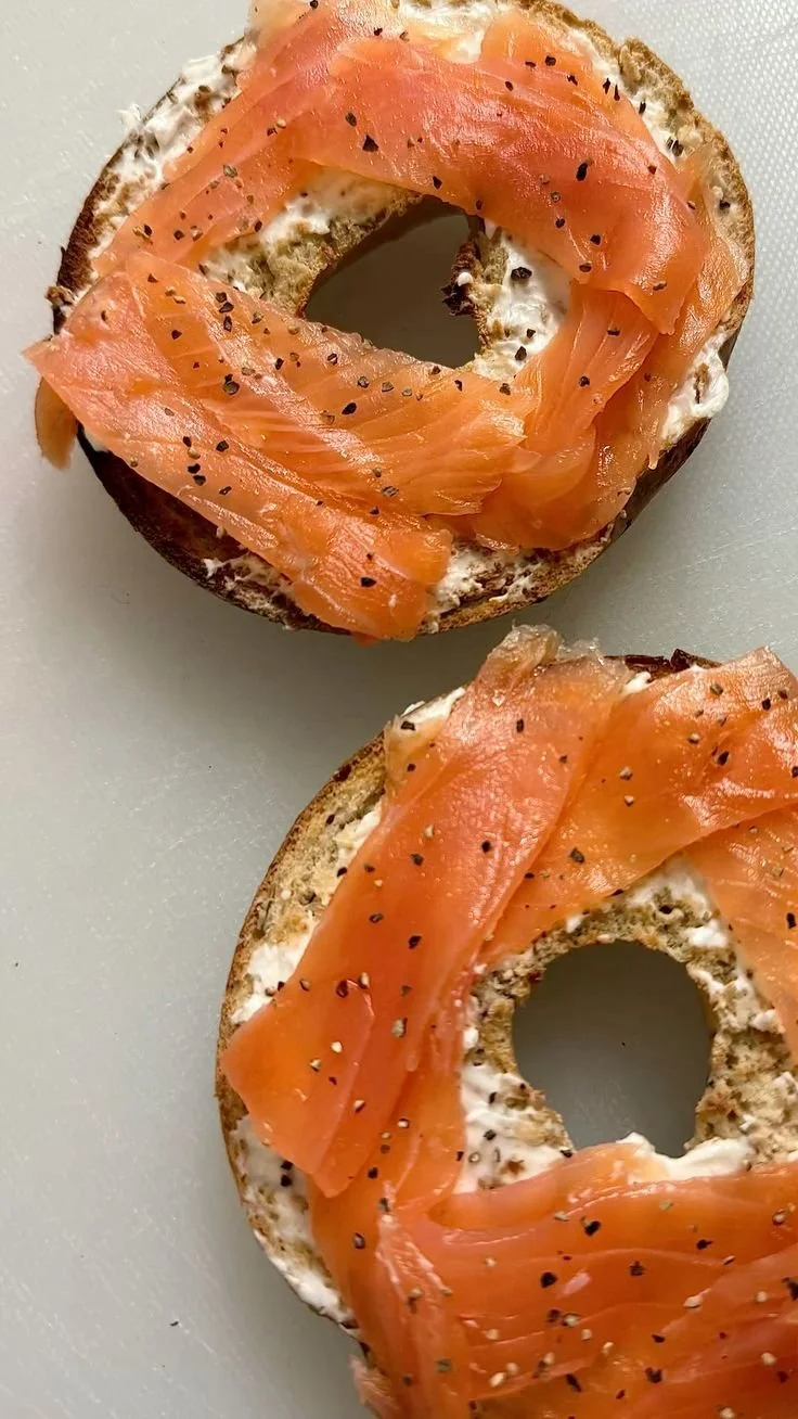 Smoked salmon cream cheese bagel topped with capers and dill on a plate