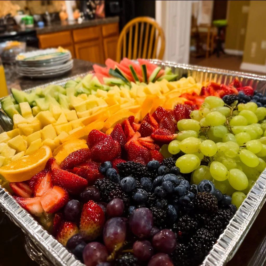 Colorful fruit trays arranged for a summer picnic with fresh fruits.
